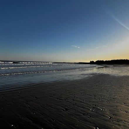 Martinique Beach at sunset, waves rolling in on dark sand